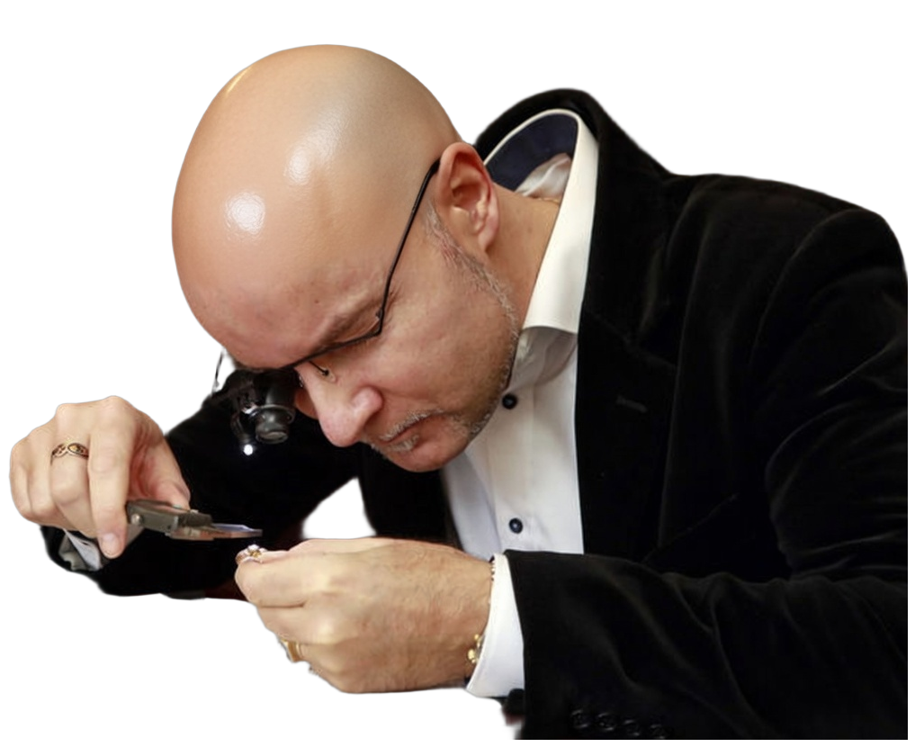 Marcus Brockmöller, a sworn jewelry appraiser in Kevelaer, examining a ring at his desk